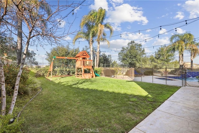 view of yard featuring a fenced in pool, a playground, and fence