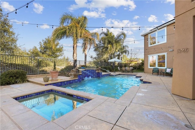 view of swimming pool with a fenced in pool, an in ground hot tub, a fenced backyard, and a patio area