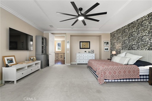 bedroom with a ceiling fan, baseboards, a tray ceiling, light carpet, and crown molding