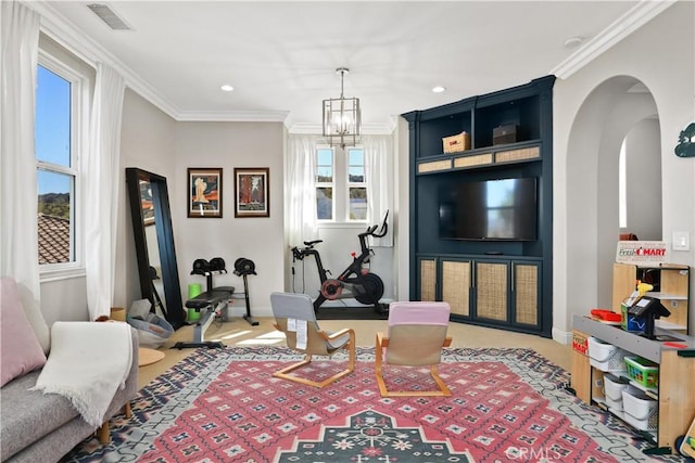 interior space featuring visible vents, ornamental molding, arched walkways, an inviting chandelier, and baseboards