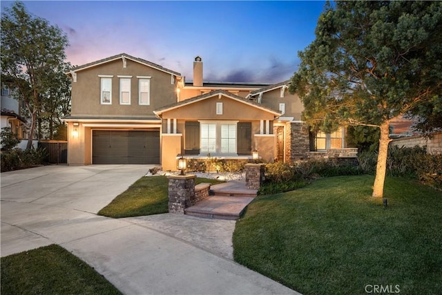 traditional-style home with a front lawn, concrete driveway, stucco siding, a chimney, and a garage