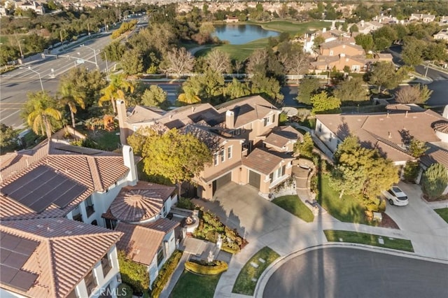 drone / aerial view with a residential view and a water view