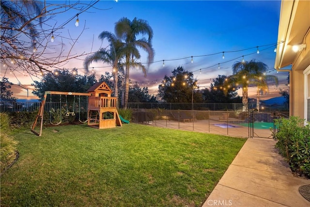 view of yard featuring a fenced in pool, fence private yard, a playground, and a patio