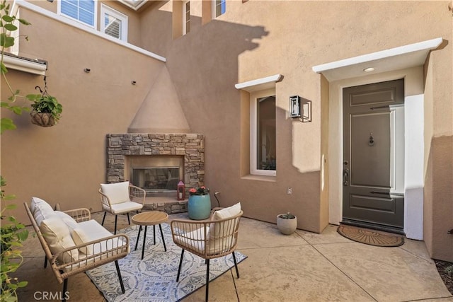 view of patio / terrace with an outdoor living space with a fireplace