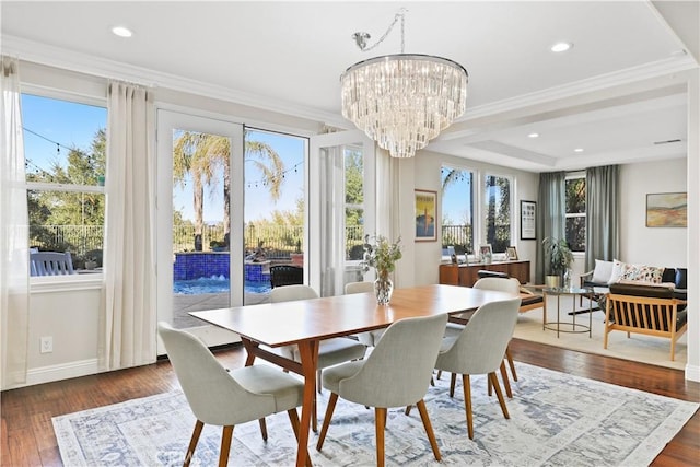 dining room featuring hardwood / wood-style floors, recessed lighting, an inviting chandelier, crown molding, and baseboards