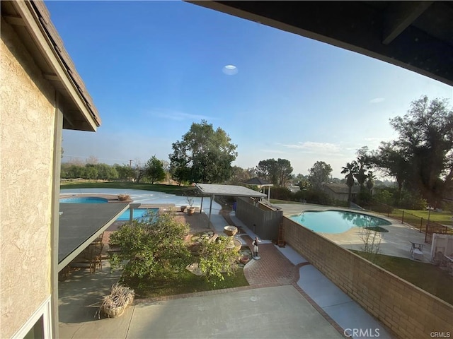 view of pool with a fenced in pool and a patio