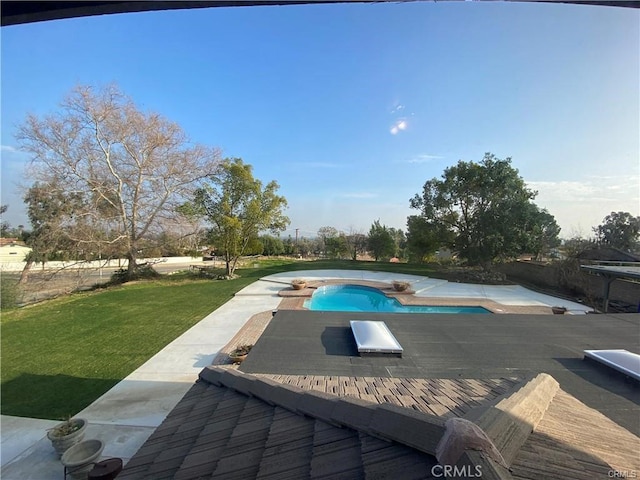 outdoor pool featuring a patio area and a yard