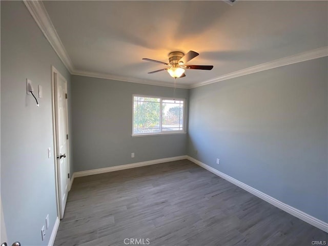 unfurnished bedroom with wood finished floors, baseboards, and ornamental molding