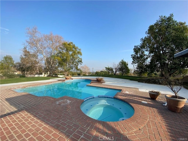 view of pool featuring a patio and a pool with connected hot tub