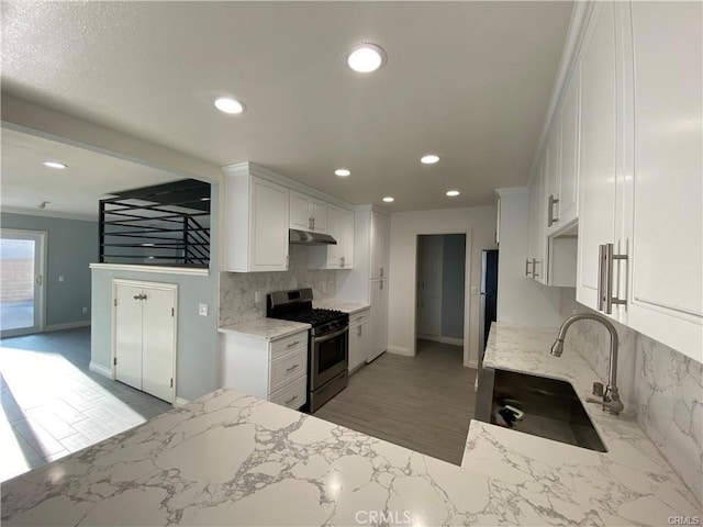 kitchen featuring a sink, appliances with stainless steel finishes, and white cabinets