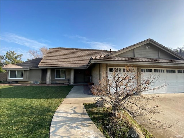 ranch-style home featuring a garage, concrete driveway, a front yard, and a tile roof