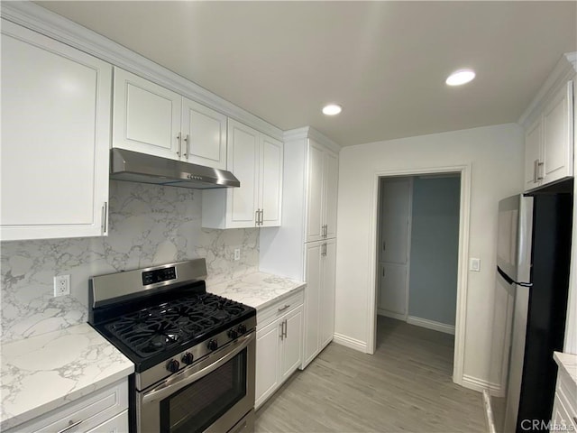 kitchen with white cabinets, tasteful backsplash, under cabinet range hood, and stainless steel appliances