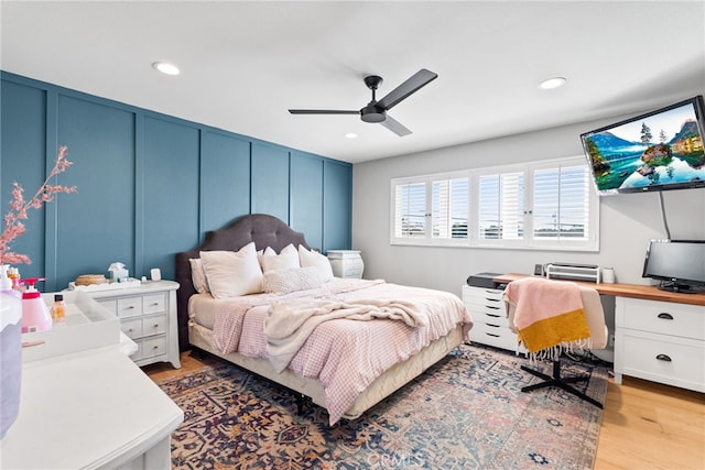 bedroom with a decorative wall, recessed lighting, light wood-style floors, and ceiling fan