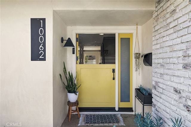 entrance to property featuring stucco siding