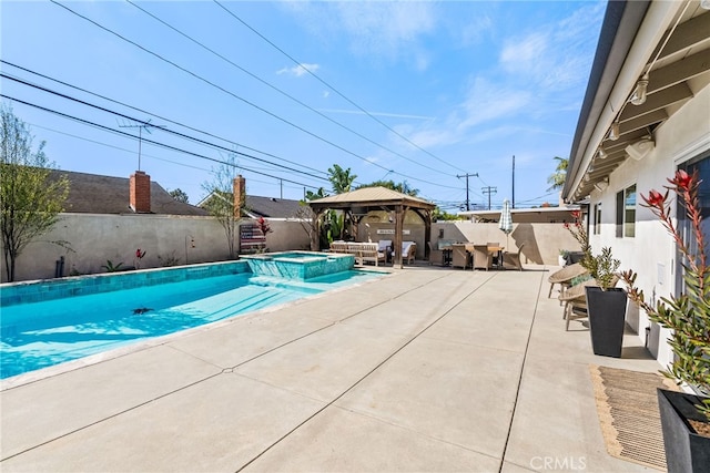 view of swimming pool featuring a gazebo, a patio area, fence private yard, and a pool with connected hot tub