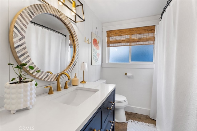 bathroom featuring toilet and vanity