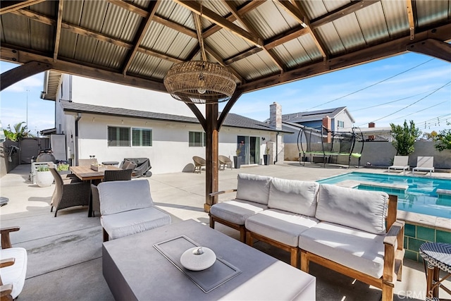 view of patio featuring fence, a gazebo, outdoor lounge area, outdoor dining area, and a fenced in pool