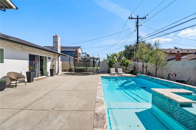 view of swimming pool with a patio area, a fenced in pool, an in ground hot tub, and a fenced backyard