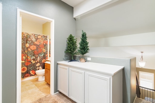 full bathroom with a shower with curtain, tile patterned flooring, vanity, and toilet