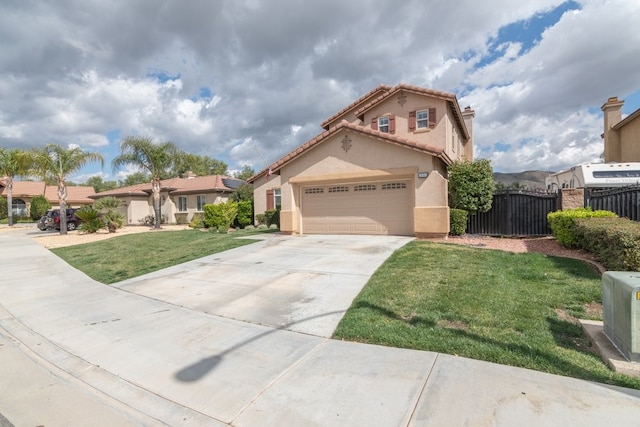 mediterranean / spanish house with stucco siding, fence, driveway, a tiled roof, and a front lawn