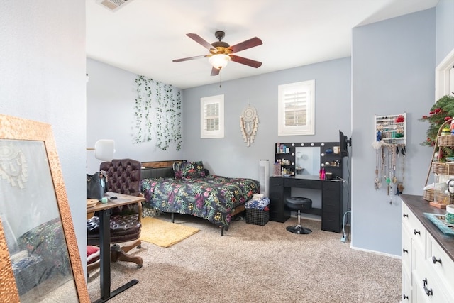 carpeted bedroom with a ceiling fan and visible vents