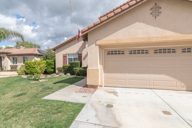 mediterranean / spanish-style house featuring stucco siding, an attached garage, driveway, a tiled roof, and a front lawn