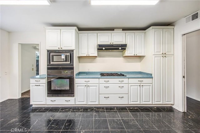 kitchen featuring under cabinet range hood, visible vents, black oven, built in microwave, and stainless steel gas stovetop