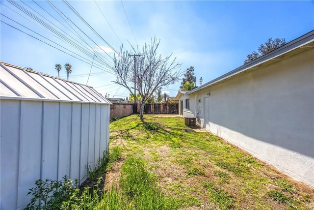 view of yard with an outbuilding and a fenced backyard