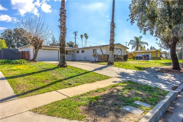 ranch-style home with a garage, driveway, a front lawn, and fence