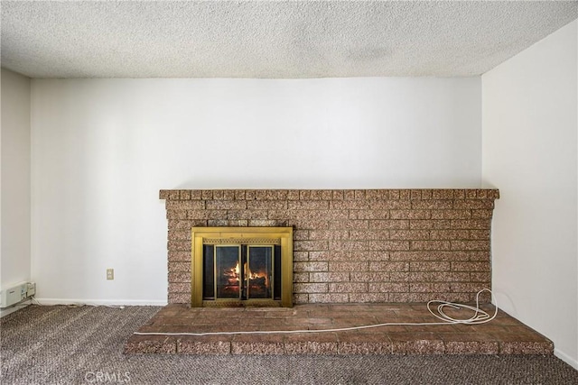 room details featuring carpet, a fireplace, a textured ceiling, and baseboards