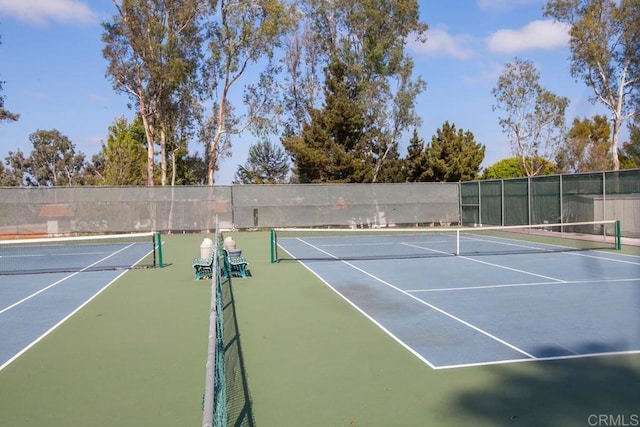 view of tennis court featuring fence