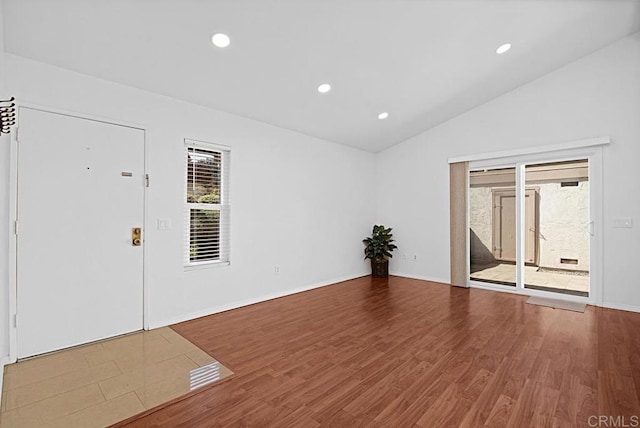 unfurnished room with lofted ceiling, wood finished floors, and recessed lighting