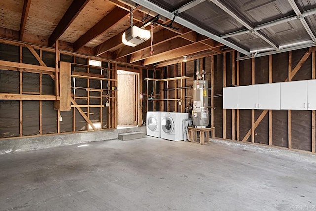 garage featuring water heater, washer and dryer, and a garage door opener