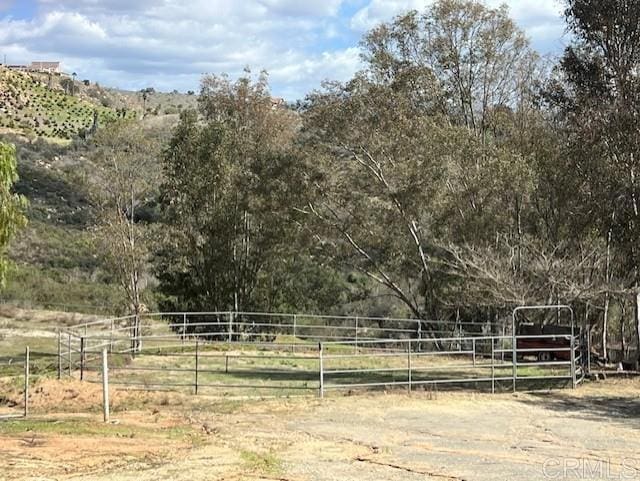 view of yard with a rural view and fence