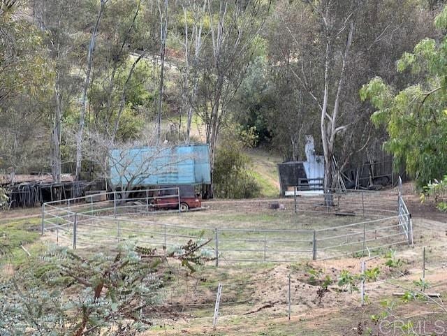 view of yard with a rural view and fence