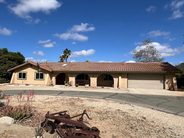 9946 Nutby Ln, Escondido, CA 92026 - view of front of house featuring stucco siding, a tiled roof, and a garage