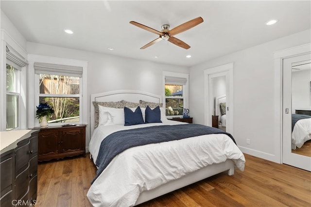 bedroom with recessed lighting, baseboards, wood finished floors, and a ceiling fan