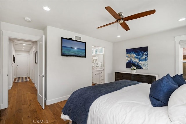 bedroom featuring visible vents, baseboards, recessed lighting, wood finished floors, and ensuite bath