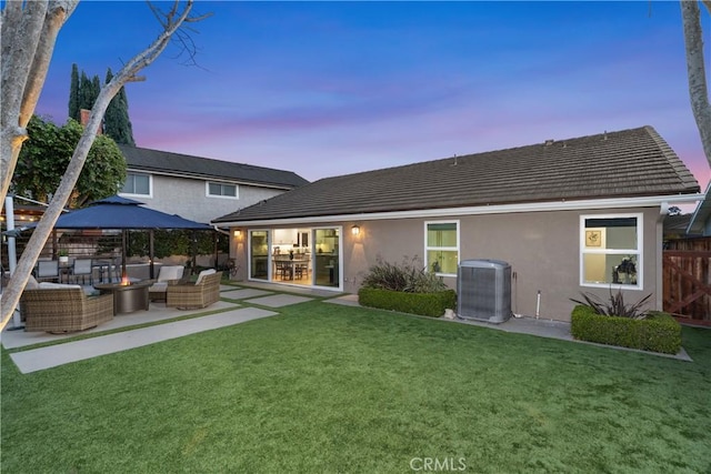 back of house with an outdoor living space, a patio, fence, a yard, and cooling unit