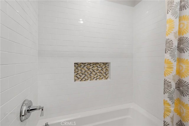 bathroom with shower / bath combo with shower curtain