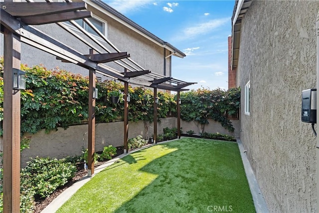 view of yard featuring a pergola and a fenced backyard