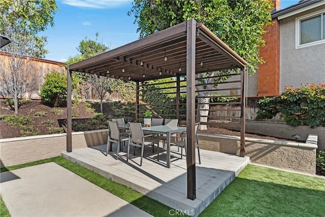 view of patio with outdoor dining area and fence