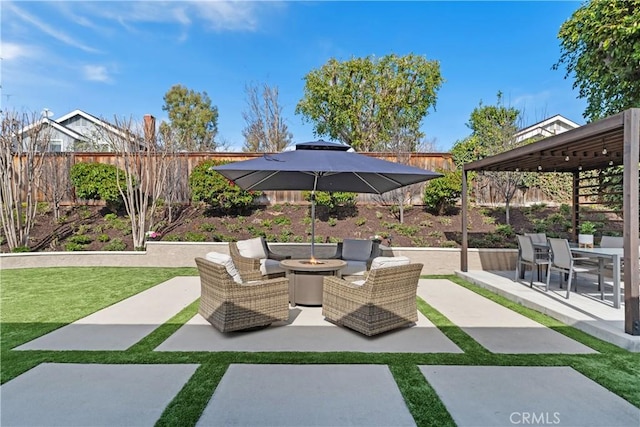 view of patio / terrace featuring outdoor dining space, an outdoor fire pit, and fence