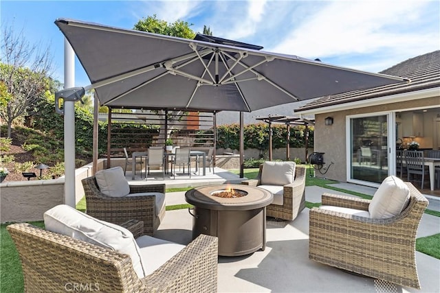 view of patio featuring an outdoor living space with a fire pit