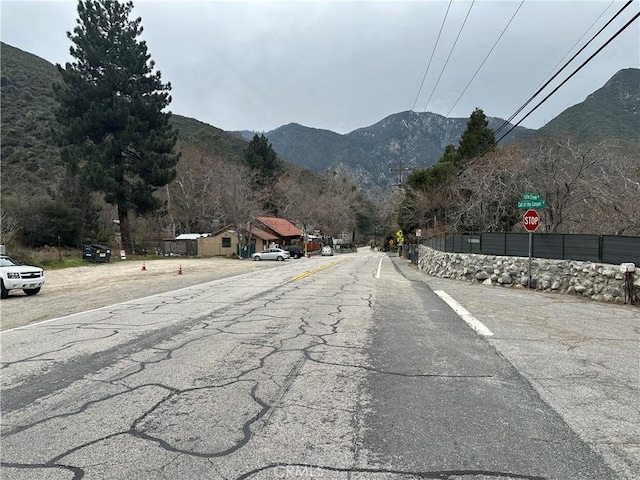 view of road with traffic signs and a mountain view