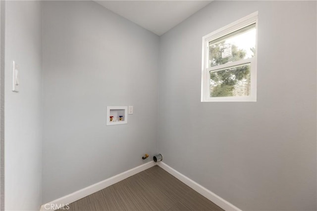 clothes washing area featuring hookup for a washing machine, laundry area, and baseboards