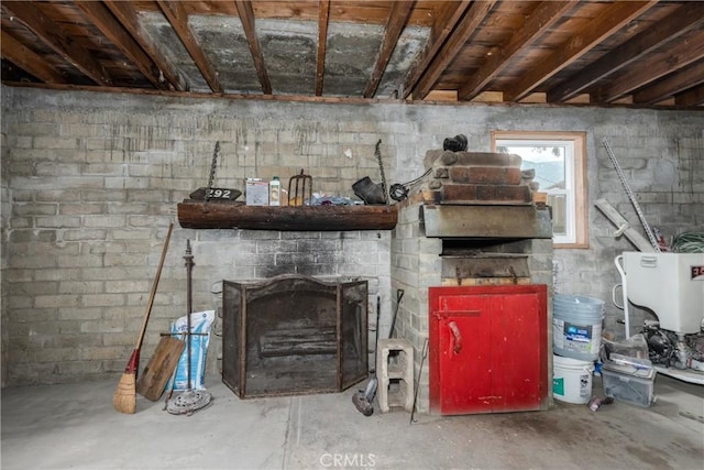 interior space featuring concrete block wall and a fireplace