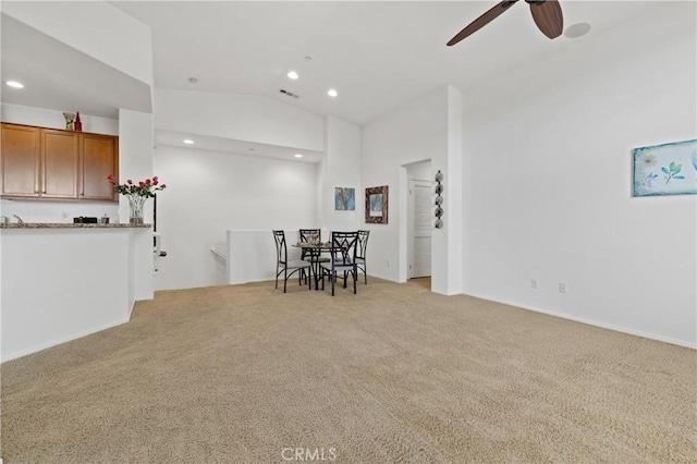 unfurnished living room with lofted ceiling, recessed lighting, visible vents, and light carpet