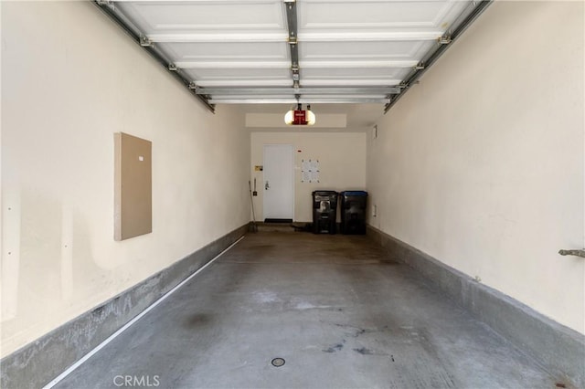 garage with electric panel and a garage door opener