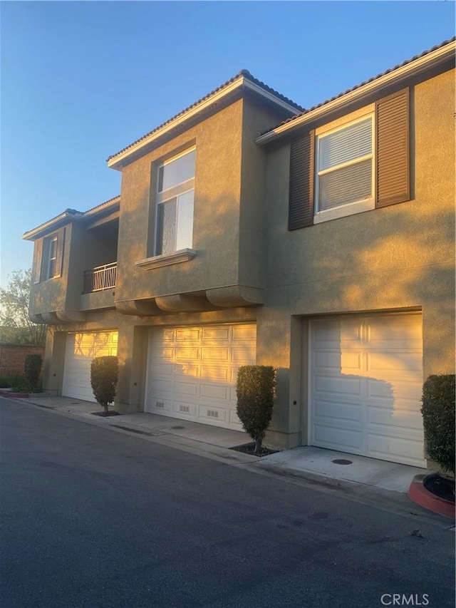 view of front of house with an attached garage and stucco siding